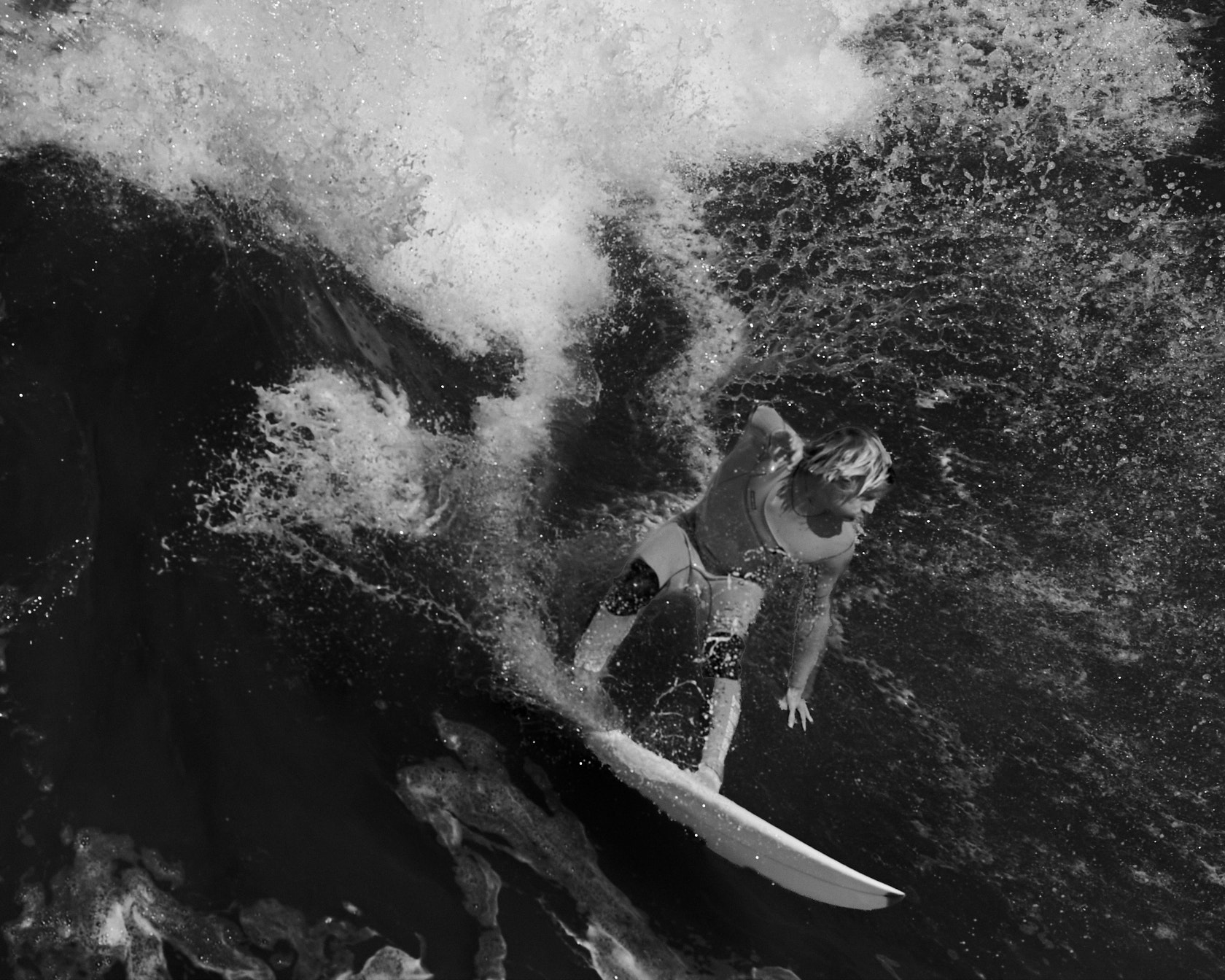 White wave with a surfer in the middle of it all